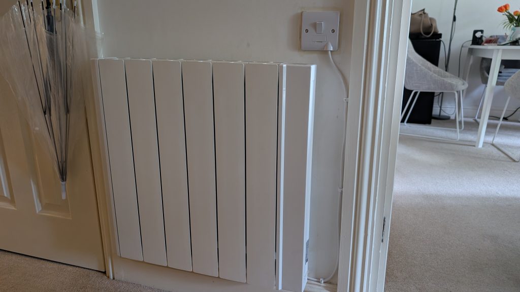 A radiator installed on a hallway wall
